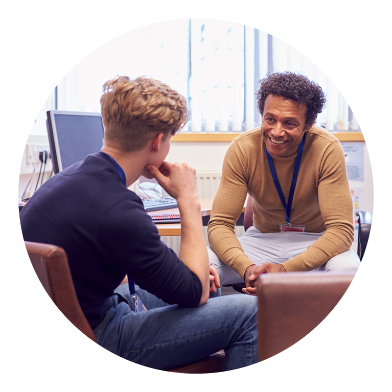 Two males talking to one another in an office