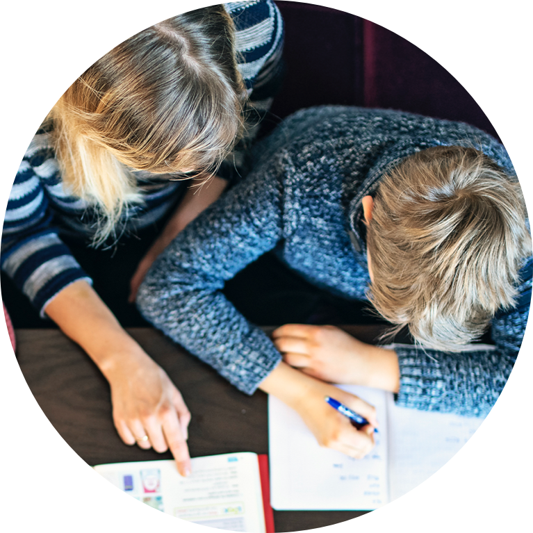 Teacher pointing at book and instructing student