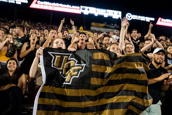 fans with UCF flag at sports game