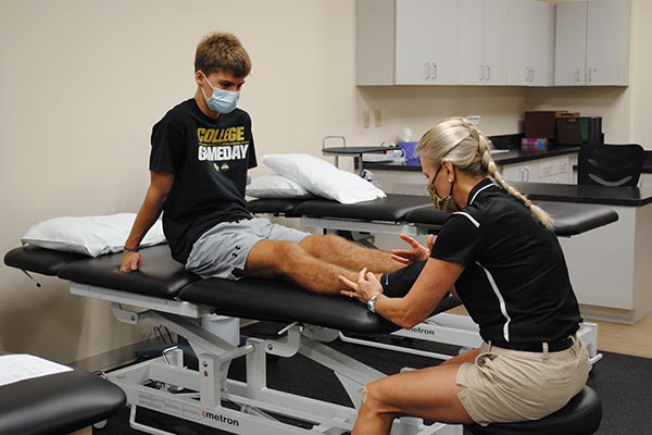 physical therapy session with expert treating a patient with an injury