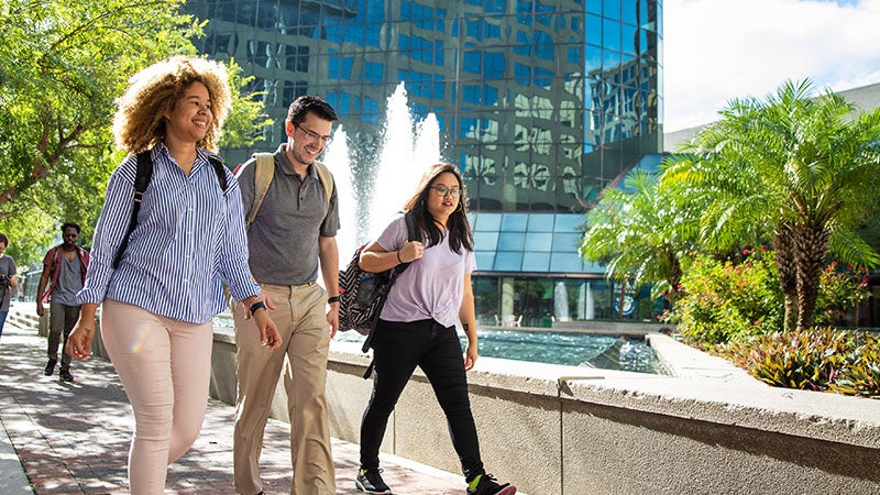 three students walking on campus