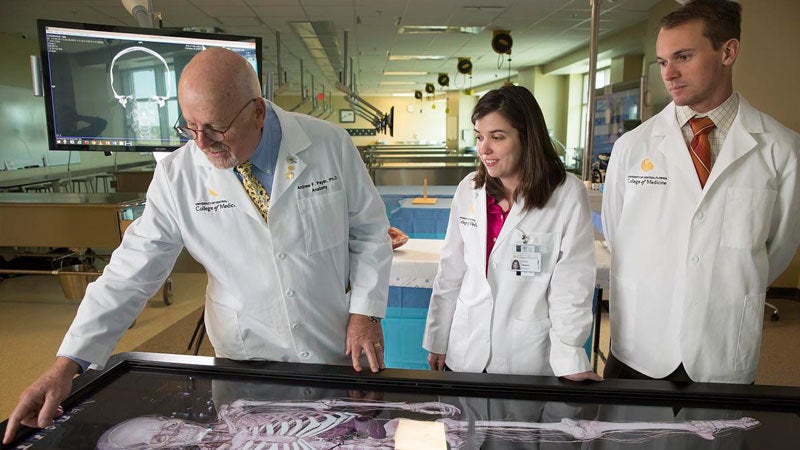 UCF professor and students using a simulator in the UCF College of Medicineâs Anatomy Laboratory