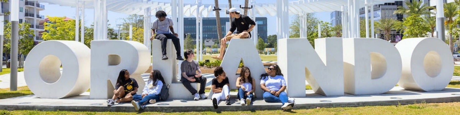 ucf out of state students hanging out on an Orlando sign