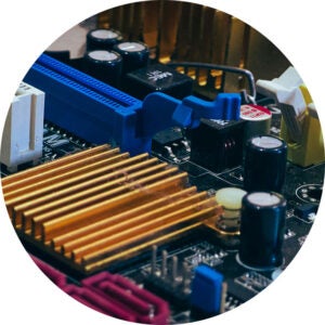 Close-up of a computer motherboard with a blue slot and gold heatsink.