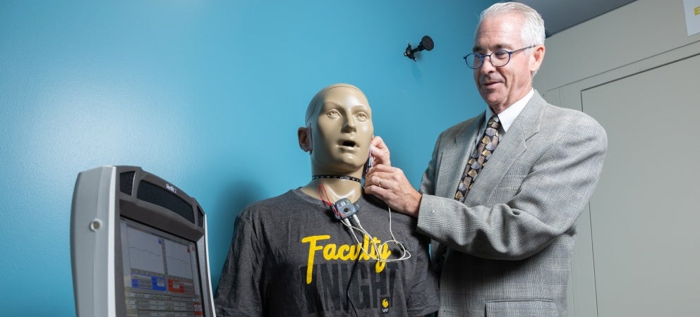 David Eddins working with acoustic manikin and verification system