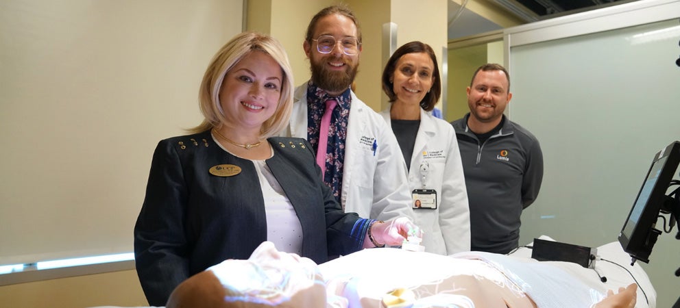 Team of UCF health and human performance researchers standing near manikin