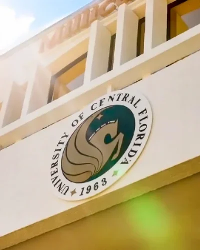 University of Central Florida seal on a campus building façade with sun flare, highlighting UCF’s national ranking.