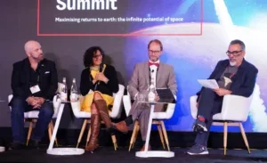 Four participants seated at The Economist's summit, focused on advancements in the space economy and related topics.