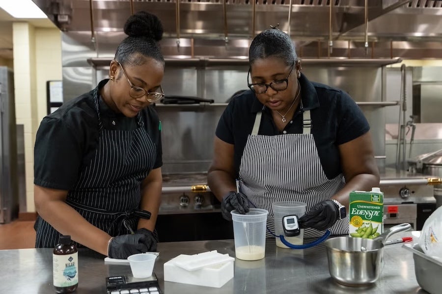 Rosen College students, Micah Pratt (left) and Ashley Scott (right) conduct a temperature check to ensure materials are at room temperature.
