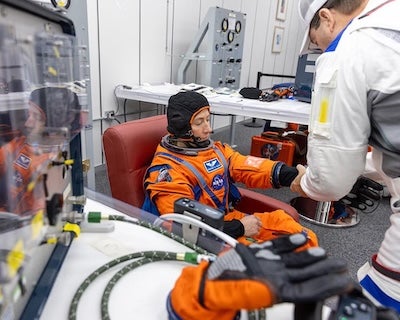 NASA astronaut, Christina Koch, Artemis II mission specialist, undergoes spacesuit checks inside the crew quarters suit-up room in the Neil A. Armstrong Operations and Checkout Building part of the Artemis II Countdown Demonstration Test at the agency’s Kennedy Space Center