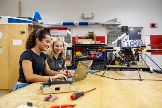 UCF students using robot dogs for autonomous systems research in the ECE lab
