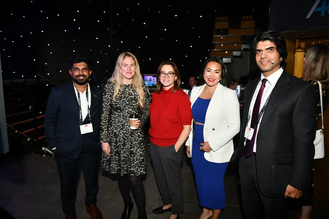 Five panelists posing together indoors at the Economist Space Economy Summit in 2025.
