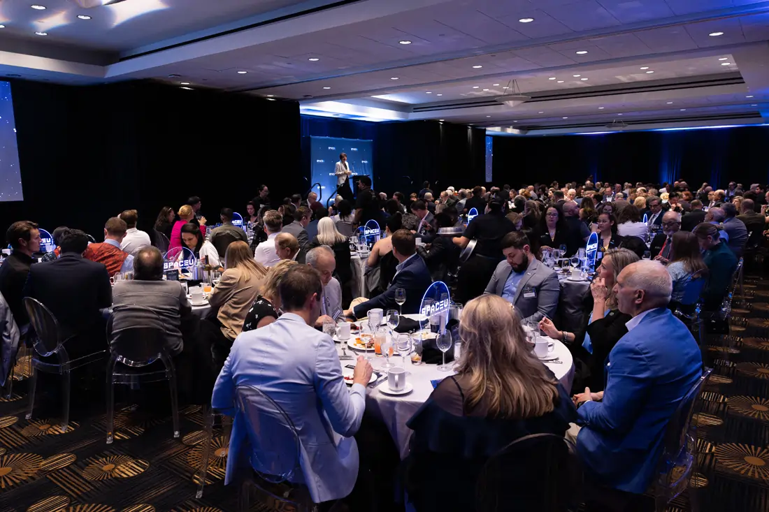 Guests seated at round banquet tables during the SpaceU Awards Dinner reception.