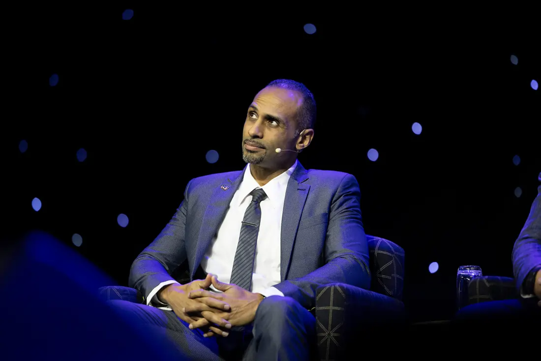 Kareem Ahmed seated on a panel discussing space policy and governance at the Economist Space Economy Summit.