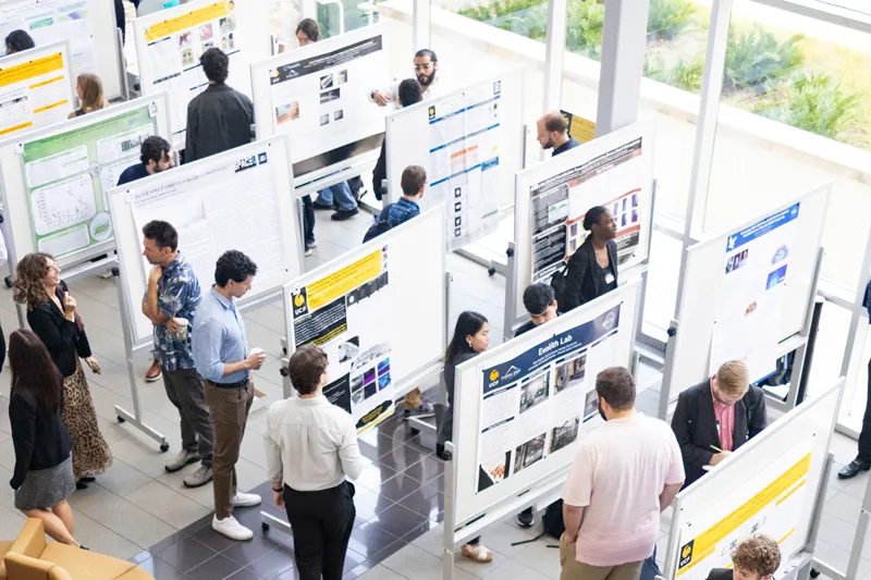 Attendees review research posters at a SpaceU Symposium.