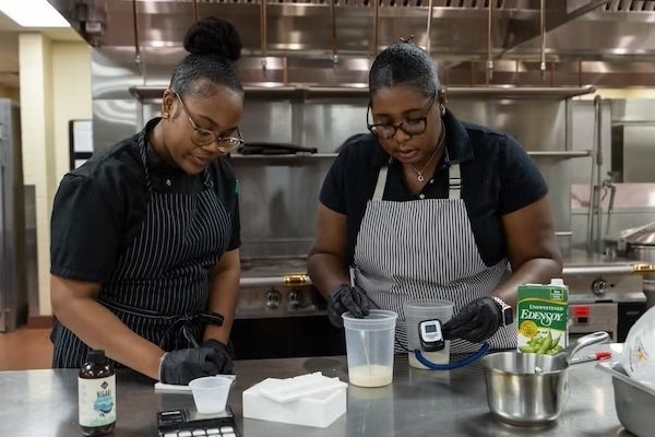 Rosen College students, Micah Pratt (left) and Ashley Scott (right) conduct a temperature check to ensure materials are at room temperature.