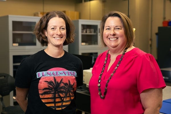 Lunar-VISE deputy-principal investigator Adrienne Dove and principal investigator Kerri Donaldson Hanna standing in a UCF lab.