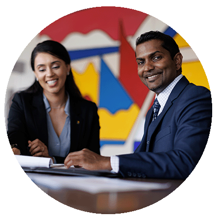 Male and female at desk.