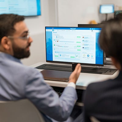 Health data analysts reviewing a dashboard 