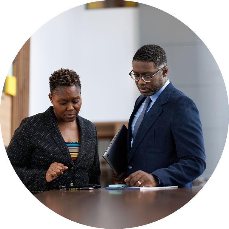 Two business professionals reviewing documents together at a table.