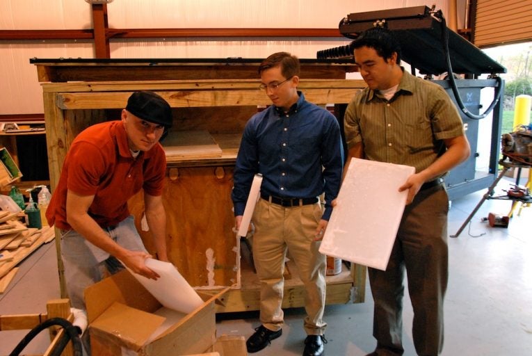 University of Central Florida Engineering students William (Pat) Baker, Matthew Jameson, and Daniel Hernandez unpack sheets of a special type of candle wax, an innovative material choice, that will allow their solar water heater to continue to heat water after the sun goes down. Heat exchanger tubes, exposed to bright sunlight, will liquify and heat the candle wax to about 140 degrees Fahrenheit. The wax will retain enough heat during the night to continue to operate the water heater. The project will be one of nineteen featured at the University of Central Florida's Second Annual Progress Energy Senior Design Symposium in Renewable and Sustainable Energy on April 14 at the UCF Student Union Building.