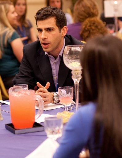 Etan Horowitz, digital media producer for CNN International (center), talks with students during “Dinner With the Pros,’’ a networking opportunity during the recent SPJ Regional Conference hosted by the Nicholson School of Communication.