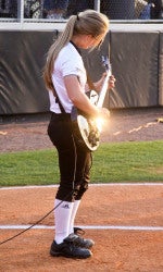 softball player playing guitar on the fild