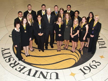 Left to right, Back row: Miguel Ubiles, Timothy Harnden, Anthony Battaglia, Patrick Stauffer, Sergio Tafur Middle row: Maribeth Ehasz, Brenna Egan, Shelly Frick, Lisa Kipersztok, President John C. Hitt, Andrea Long, Carla McKnight, Natalia Marques da Silva Front row: Jennifer Bazemore, Stephanie Koffler, Lauren Rehm, Stephanie Neubert, Amber Dukes