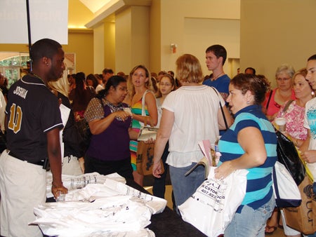 O-Teamer distributes bags of information to parents and families.