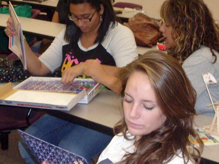 Upward Bound Scholars Sarah Fox, Aysha Pizarro and Erika Ramirez explored electrical design using snap circuits.