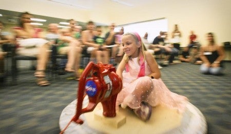 Zoe Hines, 7, rides a hover craft powered by a blower motor at the UCF Teaching Academy during NASA's science day held on Saturday, July 10. (Joshua C. Cruey, Orlando Sentinel / July 9, 2010)