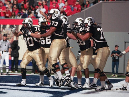 ucf football players celebrating at liberty bowl