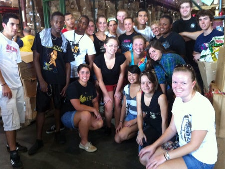 Residents of the Volunteers uKnighted commUNITY take a break after sorting food at Second Harvest Food Bank.