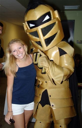 Student posed for a photo with Knightro.