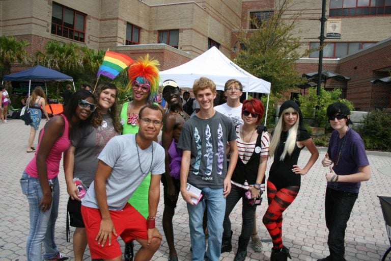 Drag queen Lady Guy and a Lady GaGa impersonator and friends pose for photo.