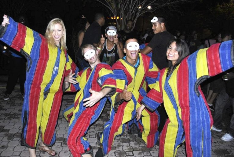 Students donned with multi-colored striped Velcro suits.