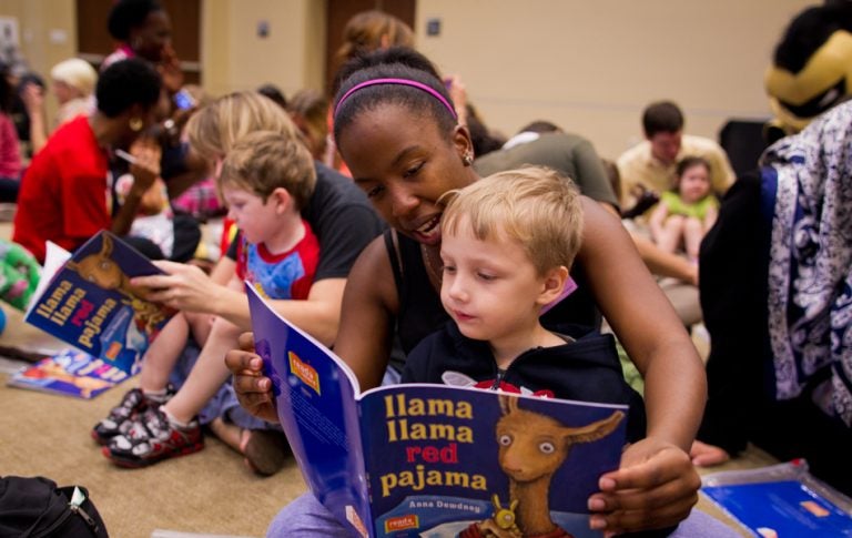 Students volunteer their time to read "Llama Llama Red Pajama" to a group of children from the Creative School for Children at the new Mordgrige Internation Center for Reading.