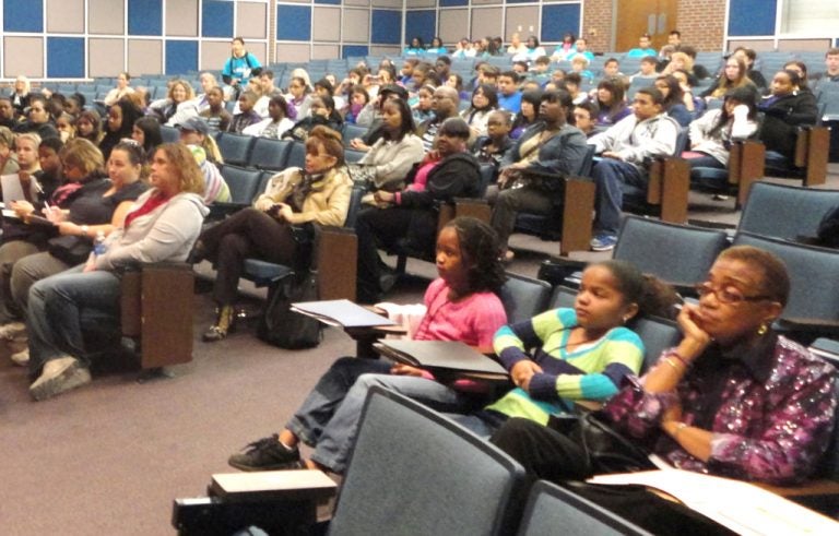 Middle and high school students listening to a presenter.