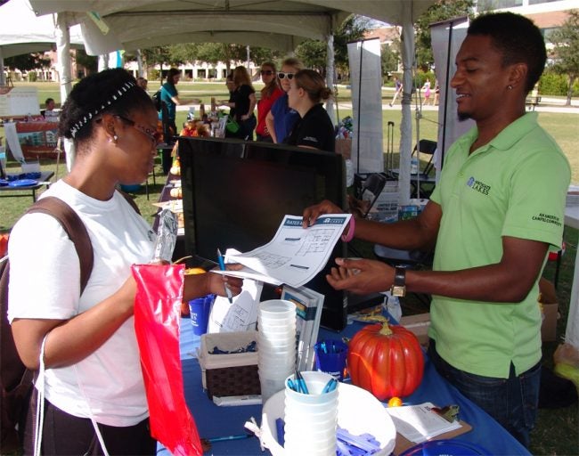 Apartment community representative provides a student information.