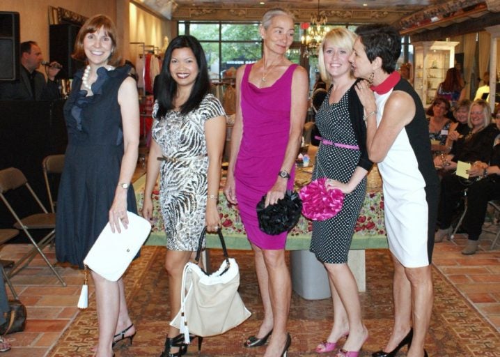 Anne Norris, Sigrid Ladores, Julee Waldrop, Heather Williams and Bella store owner Susan Johnson show their final looks at a College of Nursing fashion show fund-raiser.