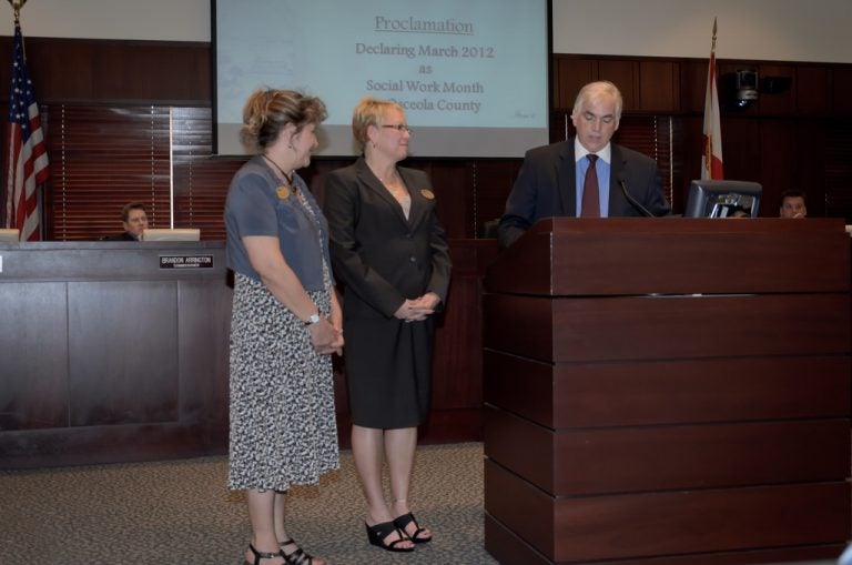 Dziegielewski (left) and Salgado listedn to Chairman Quinones read the proclamation.