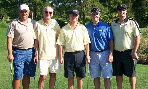 The first-place team (Jorge Magluta, Ken Tuttle, Laurence Heisler, Scott Loubier) with Interim Dean Foard Jones (second from left).