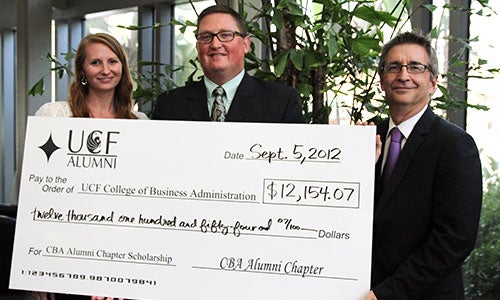 The College of Business Administration Alumni Chapter presents a check for $12,154.07 to Dr. Paul Jarley (far right), dean of the college.