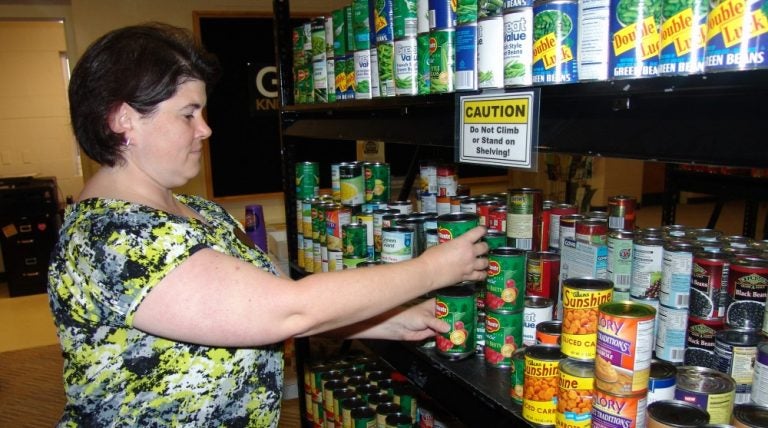 woman stocking shelves at knights pantry, homeless shelter