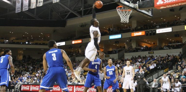 ucf basketball player dunking over louisville player