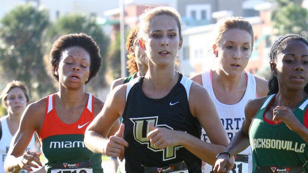 group of female ucf students running track