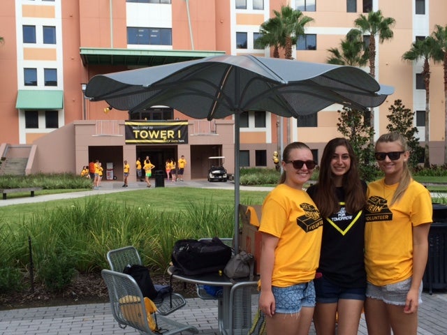 Mykala Ford, Anita Fazeli and Christa Deeks volunteer to help students move into their on-campus housing.