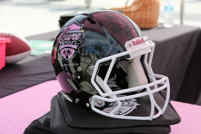 black and pink football helmet from Cure Bowl