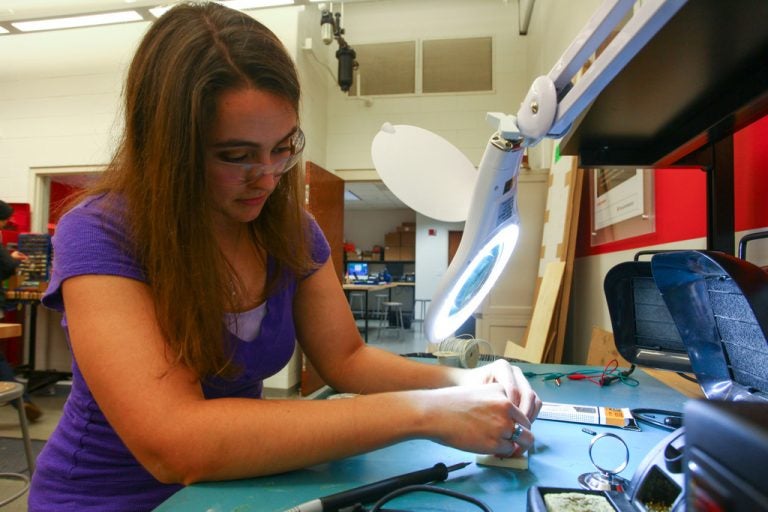 Mechanical engineering student Megan Pence, who will graduate Saturday, does work in a university engineering lab. Photo by Nick Russett