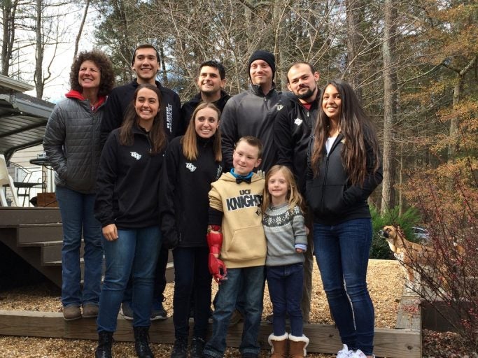 Former Olympian and UCF alumna Michelle Akers (left) hosted the latest delivery of a Limbitless Solutions arm in Powder Springs, Ga., to Lila Brooks Pearson (right front) of South Carolina.